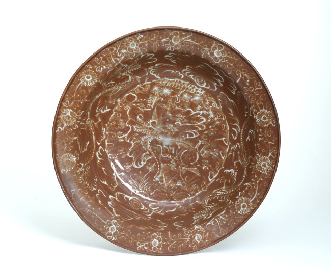 Fig. 9. Dish with slip decoration of qilin and brown glaze, Zhangzhou, China, c. 1570-1650, stoneware, d. 41.8 cm, Princessehof National Museum of Ceramics (on loan from the Ottema-Kingma Foundation), NO 02621. Photo: Johan van der Veer 
